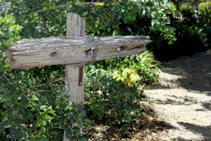 Wooden cross along a garden pathway, highlighting reflection, faith and quiet spaces within the school environment